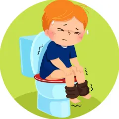 Chłopiec z zapaleniem pęcherza siedzi na toalecie, cierpiąc.
